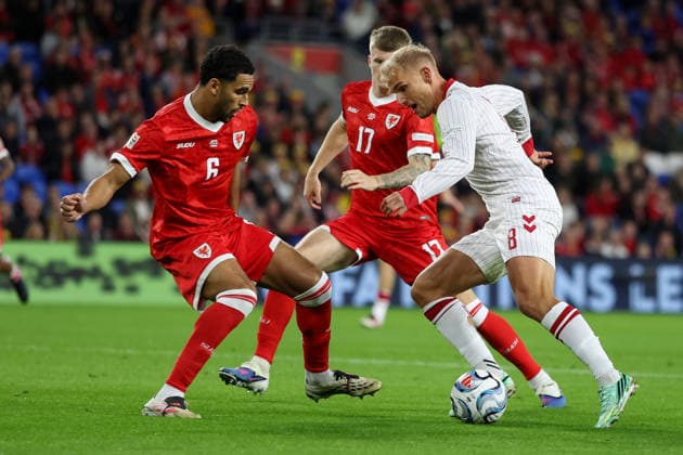 Wales v Denmark UEFA Nations League Ben Cabango (L) and Jordan James of Wales (C) attempt to tackle Gustav Isaksen of Denmark during the UEFA Nations League match at the Cardiff City Stadium, Cardiff 04 10 2026 UK Newspapers OUT Copyright: xKaraxThomasx FIL-24028-0014