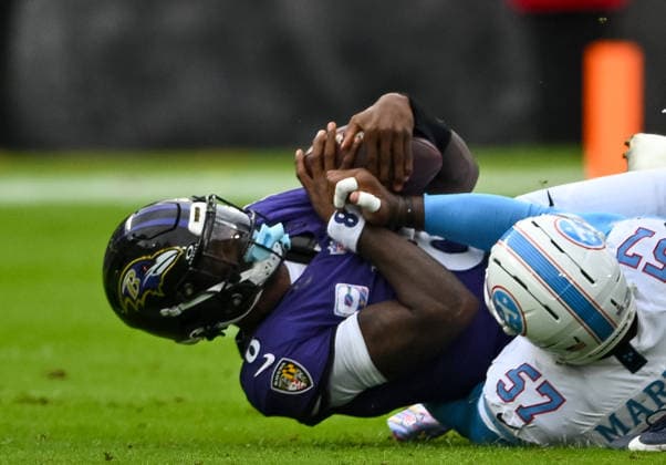Tennessee Titans defensive end Jacob Martin (57) sacks Baltimore Ravens quarterback Lamar Jackson (8) for a third down loss during the first quarter at M&T Bank Stadium in Baltimore, Maryland, on Sunday, October 4, 2026.  BAL20261004107 DAVIDxTULIS