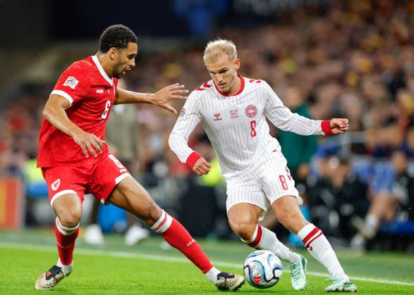 Cardiff, Wales, 4th October 2026. Ben Cabango of Wales tackles Gustav Isaksen of Denmark during the Wales vs Denmark UEFA Nations League match at the Cardiff City Stadium, Cardiff. Picture credit should read: Cody Froggatt Sportimage EDITORIAL USE ONLY. No use with unauthorised audio, video, data, fixture lists, club league logos or live services. Online in-match use limited to 120 images, no video emulation. No use in betting, games or single club league player publications. SPI_020_CF_WALES_V_DENMARK SPI-5051-0020