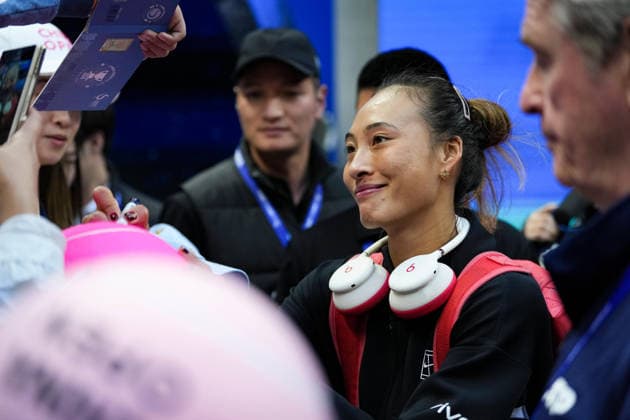 (261005) -- BEIJING, Oct. 5, 2026 -- Zheng Qinwen of China signs autograph for fans after winning the women s singles round of 32 match against Marie Bouzkova of the Czech Republic at 2026 China Open tennis tournament in Beijing, China, Oct. 5, 2026. ) (SP)CHINA-BEIJING-TENNIS-CHINA OPEN-WOMEN S SINGLES(CN) SunxFei 