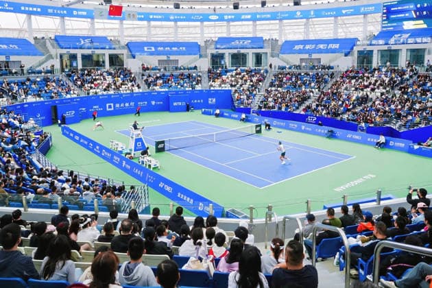 (261007) -- BEIJING, Oct. 7, 2026 -- People enjoy a match during the Jingshan Tennis Open in Jingshan, central China s Hubei Province, Oct. 4, 2026. (Photo by Xinhua) Xinhua Headlines: Small counties, big appeal: China s golden week fuels diverse getaways LeixYixin 