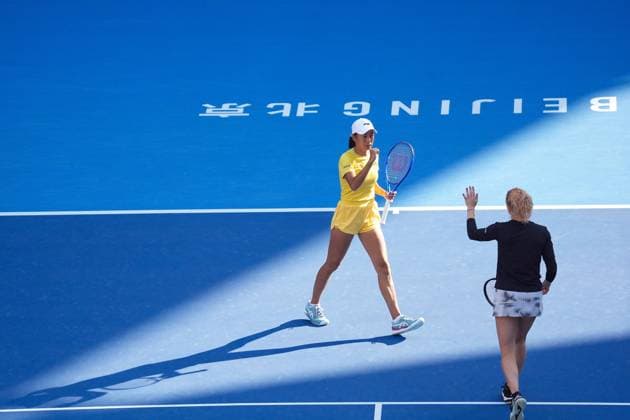 (261007) -- BEIJING, Oct. 7, 2026 -- Katerina Siniakova Zhang Shuai (L) celebrate during the women s doubles round of 16 match between Katerina Siniakova(the Cezch Republic) Zhang Shuai(China) and Nikola Bartunkova(the Cezch Republic) Maja Chwalinska(Poland) at 2026 China Open tennis tournament in Beijing, China, Oct. 7, 2026. ) (SP)CHINA-BEIJING-TENNIS-CHINA OPEN-WOMEN S DOUBLES (CN) JuxHuanzong 