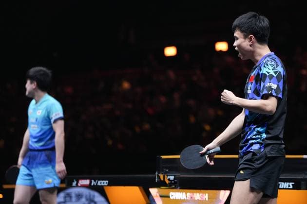 (261008) -- BEIJING, Oct. 8, 2026 -- Zhou Qihao (R) of China celebrates scoring during the men s singles round of 16 match between Zhou Qihao of China and Harimoto Tomokazu of Japan at 2026 World Table tennis, Tischtennis (WTT) China Smash in Beijing, China, Oct. 8, 2026. ) (SP)CHINA-BEIJING-TABLE TENNIS-WTT-CHINA SMASH-MEN S SINGLES (CN) JuxHuanzong 