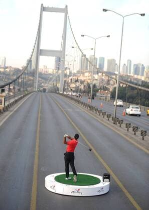Golf, Turkish Airlines Open, Tiger Woods hits golf ball from Europe to Asia on Bosphorus Bridge