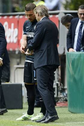 Football, Italy, Serie A, Inters Lukas Podolski is substituted with instructions on slip of paper