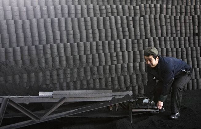 IMAGO Nature: Unsere Erde, Ressourcen, Kohle Arbeiter inspiziert eine Vorrichtung in einer Kohlebrikettfabrik in Peking - 