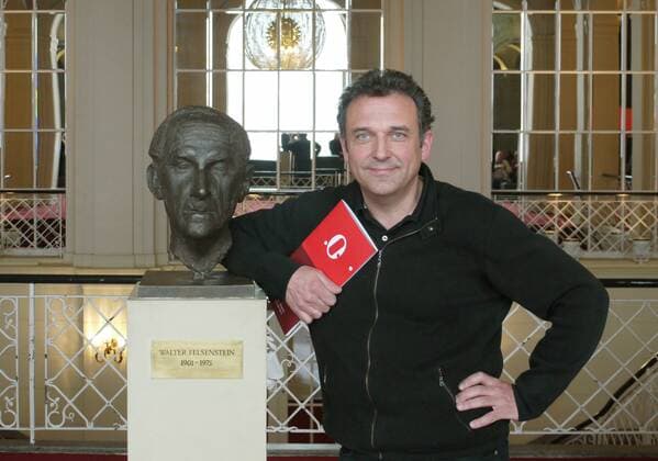 Andreas Homoki (Intendant Komische Oper Berlin) neben einer Büste von Walter Felsenstein in Berlin