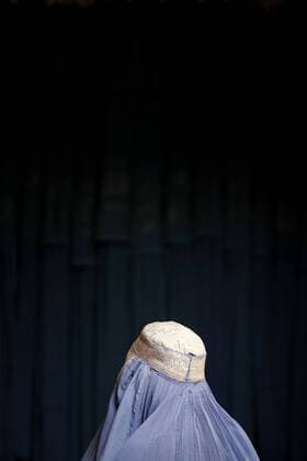 An Afghan burqa-clad woman, which is worn to cover the entire body of women in public, sits in a shop in Herat, Afghanistan on August 11, 2009. The participation of women in the upcoming August 20 election is considered vital to success of those elections. UPI Mohammad Kheirkhah Daily Life in Afghanistan  AFG20090811108