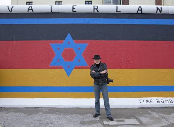 Artist Günther Schäfer stands in front of a segment of the original Berlin wall in Berlin on November 6, 2009. Schaefer painted this segment of the wall in 1990 after the fall of then East Germany and, as part of a ceremony commemorating the 20th anniversary of the fall, recently restored his work. This site, located at the East Side Gallery, is the longest, best kept segment of the original wall. UPI Photo David Silpa  BER20091106702