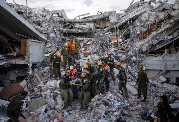 (100117) -- PORT-AU-PRINCE, Jan. 17, 2010 (Xinhua) -- Israeli rescuers retrieve an injured person from the rubbles of a ruined building in Haitian capital Port-au-Prince on Jan. 16, 2010. International rescuers are rushing to Haiti following a devastating earthquake on Jan. 12. (Xinhua David de la Paz) (nxl) (3)HAITI-QUAKE-INTENATIONAL-RESCUERS 