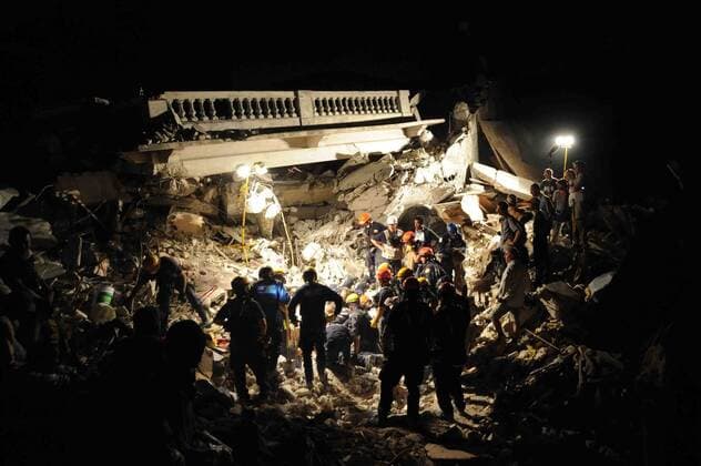 Members of the Los Angeles County Fire Department Search and Rescue Team clear debris at a collapsed building in downtown Port-au-Prince, Haiti, on January 17, 2010. Part-au-Prince was hit by a devastating 7.0 magnitude earthquake on Jan. 12, 2010.  WAX2010011805