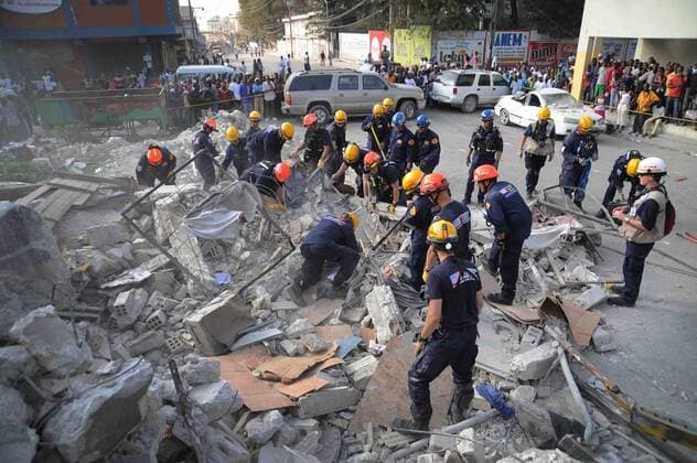 Members of the Los Angeles County Fire Department Search and Rescue Team clear debris at a collapsed building in downtown Port-au-Prince, Haiti, on January 17, 2010. Part-au-Prince was hit by a devastating 7.0 magnitude earthquake on Jan. 12, 2010.  WAX2010011893