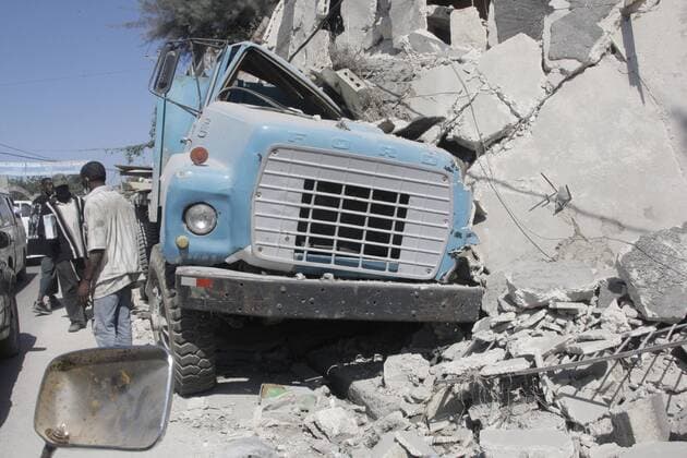 A smashed car is seen on the remains of a house in Port-au-Prince on January 18, 2010, after a 7.0 magnitude earthquake caused severe damage on January 12.  PRT2010011811