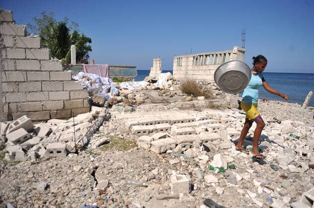 A woman walks through rubble near the town of Grand Goave, Haiti, January 22, 2010. The U.S. Navy sent in an assessment team to investigate damage from last weeks 7.0 magnitude earthquake and the several aftershocks that followed.  HAI20100122302