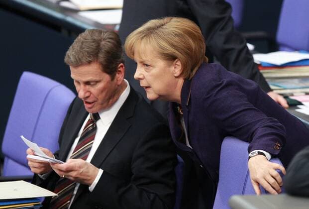 (100507) -- BERLIN, May 7, 2010 (Xinhua) -- German Chancellor Angela Merkel (R) talks with German Foreign Minister Guido Westerwelle at the lower chamber of parliament on the Greece rescue package in Berlin May 7, 2010. Germany s lower chamber of parliament on Friday approved its share in a multi-billion-euro rescue package for debt-laden Greece. (Xinhua Luo Huanhuan)(dyw) GERMANY-BERLIN-GREECE RESCUE PACKAGE 