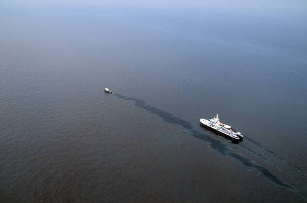 Crews work on May 8, 2010, collect oil near and around the location where the Deepwater Horizon oil platform caught fire and sank in the Gulf of Mexico. At least 193 vessels are assisting in the oil spill recovery after the platform sank April 20, 2010. UP ICasey J. Ranel USCG  WAX2010051009