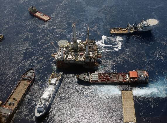 Work boats surround one of the rigs that is drilling a relief well at the site of the BP Deepwater Horizon oil leak in the Gulf of Mexico May 29, 2010. BP admitted that its top kill operation had failed to plug the well, and the company is proceeding with other efforts to stop the leak.  NOP2010052902