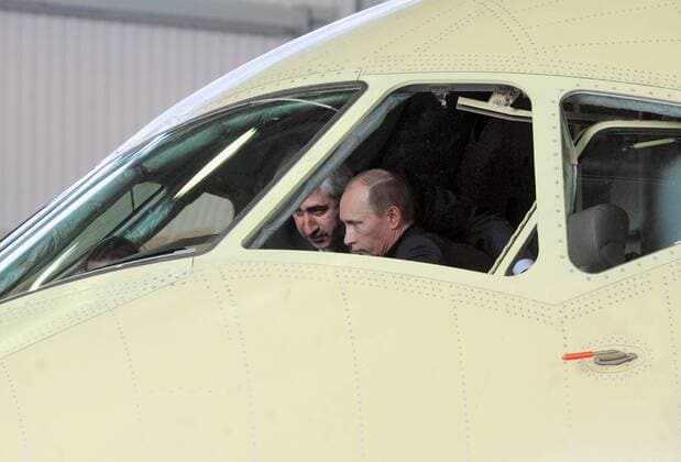 ITAR-TASS 22: KOMSOMOLSK-ON-AMUR, RUSSIA. MAY 11, 2009. Sukhoi CEO Mikhail Pogosyan (L) and Russian PM Vladimir Putin talk in the cockpit of a Sukhoi Superjet-100 passenger airplane at the Gagarin assembly plant.  Highlight 777446