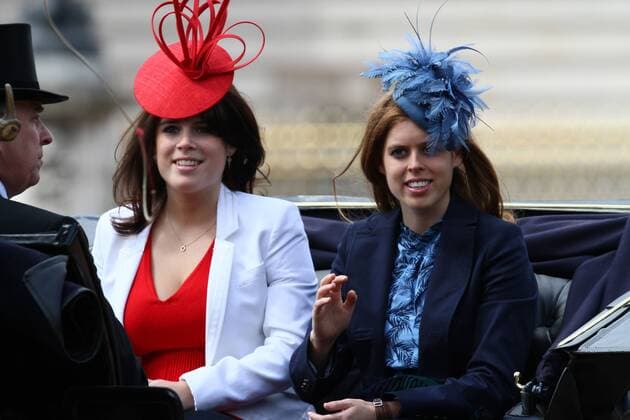 Trooping the Colour - Princess Eugenie (C) and Princess Beatrice ride in a carriage down The Mall, with their father Prince Andrew (left). 