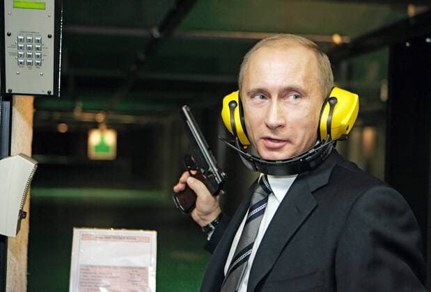 ITAR-TASS 91: MOSCOW, RUSSIA. NOVEMBER 8. Russian President Vladimir Putin wears ear defenders and holds a pistol on a visit to a new headquarters of the Main Intelligence Agency (GRU) of the Russian Armed Forces General Staff.  Highlight 379656