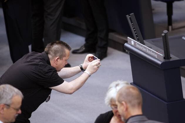 Berlin, den 30.06.2010 - Deutscher Bundestag 14. Bundesversammlung zur Wahl des Bundespräsidenten Foto: Sebastian Krumbiegel von der Gruppe Die Prinzen und nominiert als Wahlmann, fotografiert das Rednerpult mit dem Schriftzug Deutscher Bundestag im Plenarsaal.