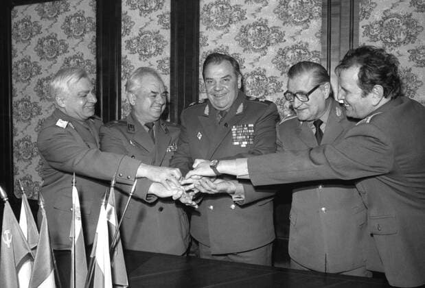 MOSCOW, USSR. Major General Mircea Constantinescu of Romania, Major General Penyu Kostadinov of Bulgaria, Army General Vladimir Lobov of the USSR, Robert Szeles of Hungary and Michal Gondek of Czechoslovakia (L-R) shake hands at the last meeting of the top brass from the Warsaw Pact (Warsaw Treaty of Friendship, Cooperation and Mutual Assistance) member states, on 25. 03. 1991.  219657