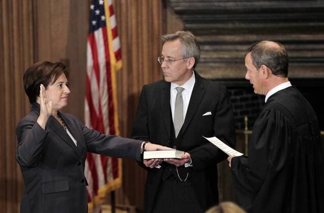 Elena Kagan (L) is sworn in as the Supreme Court s newest member as Chief Justice John Roberts (R) administers the judicial oath at the Supreme Court Building in Washington on August 7, 2010. The Bible is held by Jeffrey Minear counselor to the chief justice. Kagan, 50, who replaces retired Justice John Paul Stevens, becomes the fourth woman to sit on the high court and is the first Supreme Court justice in nearly four decades with no previous experience as a judge.  WAX20100807702