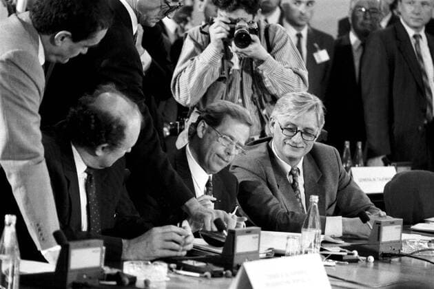 FILE - A July 1, 1991 file photo of Czechoslovakia s Premier Marian Calfa, left, and Foreign Minister Jiri Dienstbier, right, look on as President Vaclav Havel, centre, signs final documents formally ending the Warsaw Pact (Treaty) at the last session of its political committee in Prague. Dienstbier died on Saturday, Jan. 8, 2011, after a long disease in a Prague hospital, aged 73. Former dissident and journalist, Dienstbier was a Czech senator at present. (CTKxPhoto PetrxMaticka) CTKPhoto5500130463