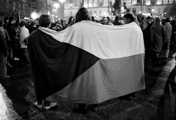 A brutal police action against peaceful march of students in Prague on November 17, 1989, sparked the Velvet Revolution, a series of demonstrations that toppled the authoritarian Communist regime in Czechoslovakia. Youngsters wrapped in Czechoslovak national flag during a demonstration in Wenceslas Square in Prague on November 22, 1989. CTK Photo Jaromir Cejka  CTKPhoto200910301222701