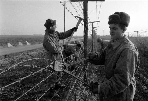 Soldiers tear down barbed wire fence near Hate at Czechoslovak-Austrian border after the Velvet revolution toppled communist regime in Czechoslovakia, November 1989. CTK Photo Igor Zehl  CTKPhoto00104213