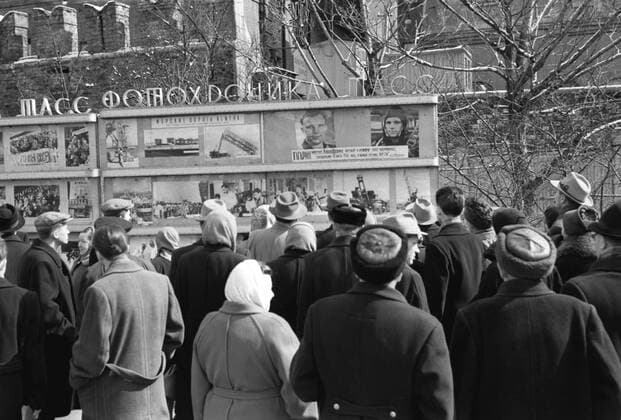 Moscow. USSR. Muscovites listening to TASS information on putting the spaceship Vostok into orbit and its successful landing on the Earth. Near Photo TASS stand.  TASS_276206