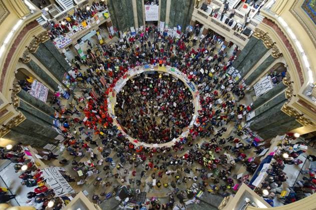 Protesters gather in the rotunda of the state Capitol in Madison, Wisconsin on February 24, 2011. Protests over budget legislation continued for the 11th day as a bill slashing benefits and revoking collective bargaining rights from state workers nears passage.  BKX2011022514