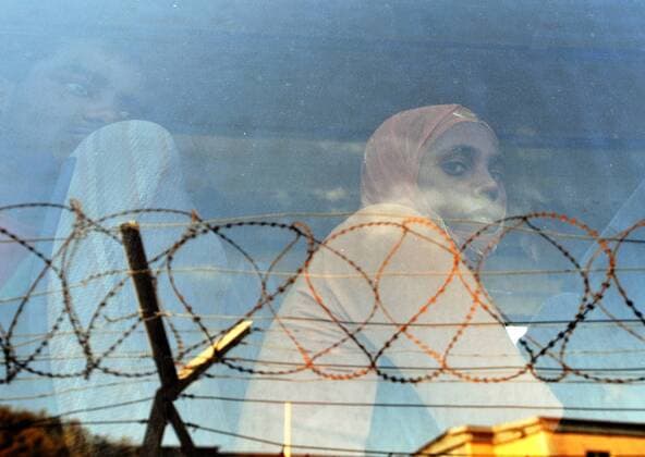(110330) -- LAMPEDUSA, March 30, 2011 (Xinhua) -- Illegal immigrants from North Africa depart from a refugee center on Lampedusa island, southernmost Italy, March 29, 2011. Some 18,000 North African immigrants, mainly from unrest-torn Libya and Tunisia, have been flooding the small Italian island of Lampedusa, which is only 110 km away from Africa. More immigrants are expected to land here as the Libyan crisis deepens. Italy will send more ships with a total capacity of 10,000 berths to evacuate migrants on Lampedusa starting from Wednesday. (Xinhua Wang qingqin) (yc) ITALY-LAMPEDUSA-NORTH AFRICAN IMMIGRANTS 