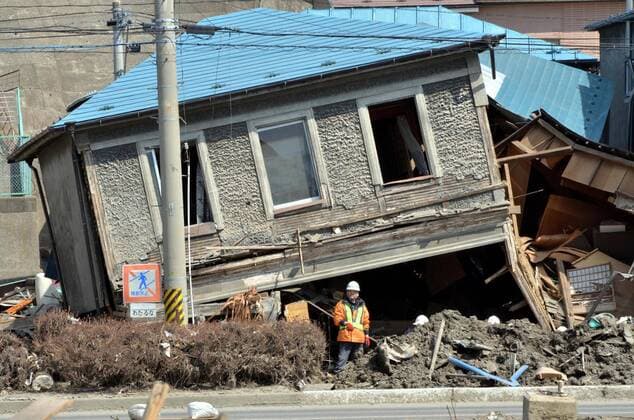 April 1st, 2011, Miyako, Japan - The upstairs of a two-story townhouse sits precariously in Miyako City, Iwate Prefecture, on April 1, 2011, three weeks after the city was devastated by a magnitude 9.0 earthquake and ensuing tsunami.  (ayfa004605)