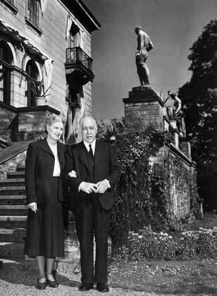 Copenhagen , Denmark - Professor Niels Bohr and his charming wife on the steps of Carlsberg House where they lived for thirty years . When brewery owner Jacobsen died in 1887 he left a clause in his will to the effect that his villa should be placed at the disposal of a person of high merit . Mrs Bohr will continue to live in the house for about six months during which time the Danish Society of Sciences are considering possible candidates to move ito the villa - 21st November 1962 ©TopFoto Mono Negative UnitedArchives1205436