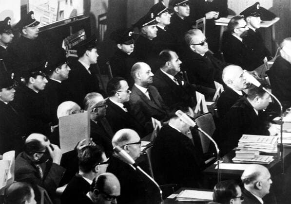 Eight of the 22 defendants in the Auschwitz trial sit between defence counsels (right) and police during the 32nd session of the marathon war crimes trial . Shown from LtoR , the accused are ; Josef Klehr (supporting head) ; Robert Milka , hiding his face ; Emil Bedmarek ; Stephan Baretzki ; Emil Hantl ; Oswald Kaduk ; Dr Victor Capesius and Wilhelm Boger . 7 April 1963 Mono Negative !AUFNAHMEDATUM GESCHÄTZT! UnitedArchives1273000