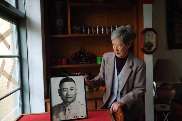 (111227) -- KAOHSIUNG, Dec. 27, 2011 (Xinhua) -- Photo taken on Dec. 23, 2011 shows a 86-year-old widow presenting her husband s portrait in a Juancun in Kaohsiung, southeast China s Taiwan. The villages for Kuomintang (KMT) veteran soldiers after they fled to Taiwan in 1949, are called Juancun in general, literally meaning servicemen s residential compound. Originally built as temporary shelters surrounded by bamboo fence, Juancun later became permanent settlements for veterans as hopes of returning to the mainland faded away. They were home to various dialects and cuisines as the residents came from different parts of the mainland. The villages are gradually disappearing nowadays because many descendants are no longer willing to stay. By the end of June, 2012, six Juancuns of Kaohsiung will be removed. (Xinhua Jin Liangkuai) (mp) CHINA-TAIWAN-JUANCUN-COUPLES (CN) 