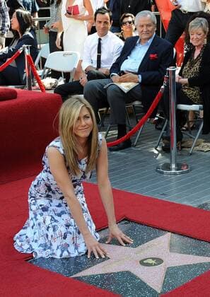 Actor Justin Theroux (L), the boyfriend of actress Jennifer Aniston and her father, actor John Aniston look on during an unveiling ceremony honoring her with the 2,462nd star on the Hollywood Walk of Fame in Los Angeles on February 22, 2012.  LAP2012022244