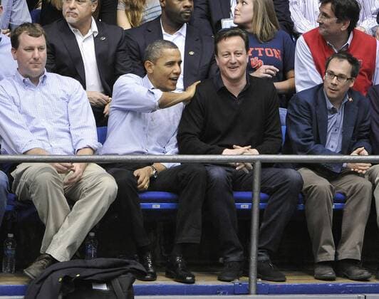U. S. President Barack Obama (L) and United Kingdom Prime Minister David Cameron watch Mississippi Valley State University play Western Kentucky in the first round of the NCAA Division I Men s Basketball Championship at the University of Dayton Arena on March 13, 2012 in Dayton, Ohio.  BKX2012031301