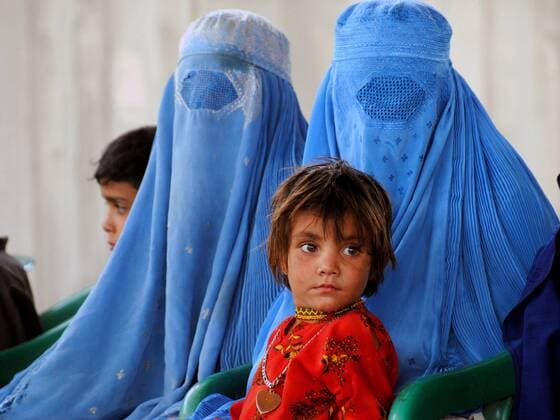 (120620) -- PESHAWAR, June 20, 2012(Xinhua) -- An Afghan refugee girl sits with her mother at the United Nations High Commissioner for Refugees (UNHCR) registration centre prior to returning to Afghanistan, on the outskirts of northwest Pakistan s Peshawar on June 20, 2012, the World Refugee Day. The United Nations refugee agency plans to help in the voluntary repatriation of some 150,000 Afghan refugees from Pakistan this year, an official from UNHCR said. (Xinhua Umar Qayyum) PAKISTAN-PESHAWAR-WORLD REFUGEE DAY 