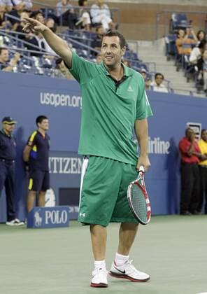 Adam Sandler reacts with fans while playing in a doubles exhibition match with Kevin James, Jim Courier, and John McEnroe on day 11 in Arthur Ashe Stadium at the Billie Jean King National Tennis Center in New York City on September 6, 2012.  NYP20120906134