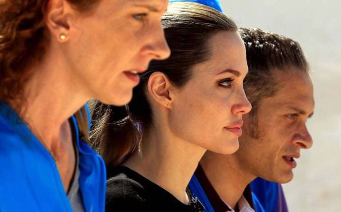 (120911) -- MAFRAQ, Sept. 11, 2012 (Xinhua) -- Actress Angelina Jolie (C), UN refugee agency s special envoy, arrives at Al Zaatri refugee camp in the Jordanian city of Mafraq, near the border with Syria, Sept. 11, 2012. The refugee camp is hosting Syrian refugees displaced by the conflict. (Xinhua Mohammad Abu Ghosh) (zyw) JORDAN-MAFRAQ-ANGELINA JOLIE-VISIT 