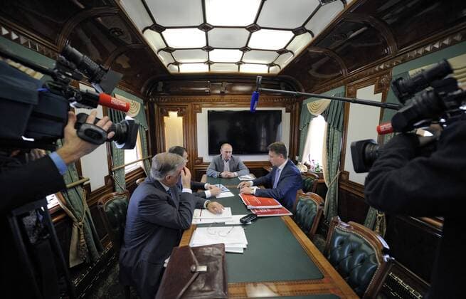ITAR-TASS: MOSCOW, RUSSIA. OCTOBER 19, 2012. Russian Railways head Vladimir Yakunin, deputy prime minister Arkady Dvorkovich, president Vladimir Putin, and transport minister Maxim Sokolov (L-R) at a meeting on rail transport development held in a train on the Moscow Little Railway Ring.  Aufmacher RE10B32B