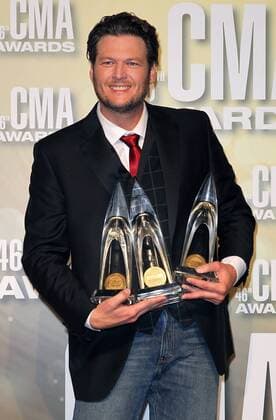 Blake Shelton, winner of Entertainer of the Year, Male Vocalist of the Year and Song of the Year, poses with his trophies backstage at the 2012 Country Music Awards at the Bridgestone Arena in Nashville on November 1, 2012.  CMA20121101164