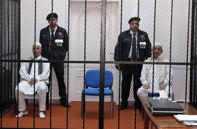 TRIPOLI, (Xinhua) -- Former Libyan congress president Mohamed Balgassem al-Zwai (L) and former Libyan foreign affairs minister Abdelati Obeidi (R) sit during the trial at a court in Tripoli, Libya, on December 10, 2012. The two former senior Libyan officials are accused of mismanaging public funds meant for compensating families of victims of the 1988 bombing of a Pan Am flight over Lockerbie. (Xinhua Hamza Turkia) (dzl) LIBYA-TRIPOLI-FORMER OFFICIALS-TRIAL 