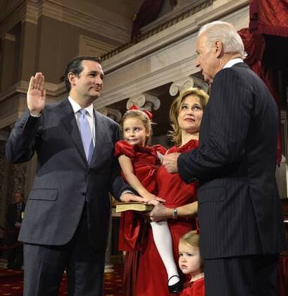 Newly-elected Sen. Ted Cruz (R-TX), (L) places his hand on a Bible held by his wife Heidi, as his children Catherine and Caroline witness as he takes part in a re-enactment of his swearing in by Vice President Joe Biden (R), in the Old Senate Chamber at the US Capitol, January 3, 2013, in Washington, DC. The senator was previously officially sworn in on the floor of the Senate to begin the 113th Congress.  WAP20130103505