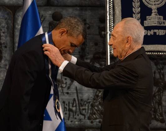 Israeli President Shimon Peres and U.S. President Barack Obama shake hands after Peres awarded the Medal of Distinction to Obama during a state dinner hosted by Peres in Jerusalem, Israel on March 21, 2013. Obama is in a three-day visit to the Middle East.  JERX20130321140