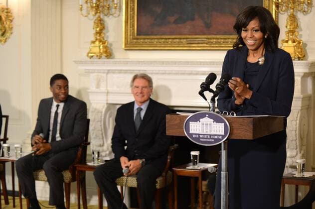 First Lady Michelle Obama speaks alongside actors Harrison Ford (C) and Chadwick Boseman as she welcomes high school and college students from across the country for a workshop with the cast and crew of the film 42, in the State Dinning Room at the White House on April 2, 2013 in Washington, D.C. Members of the cast of 42 participated in a discussion about the film, Jackie Robinson and the inspirational themes from his life that students can apply to their own.  WAP20130402316