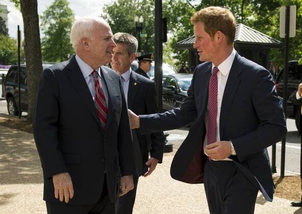 Prince Harry (R) is greeted by Sen. John McCain (R-AZ) as he arrives on Capitol Hill to tour a photography exhibit by HALO Trust, a British nonprofit focused on removing hazardous war debris, including un-exploded devices and landmines, on May 9, 2013 in Washington, D.C.  WAP20130509315