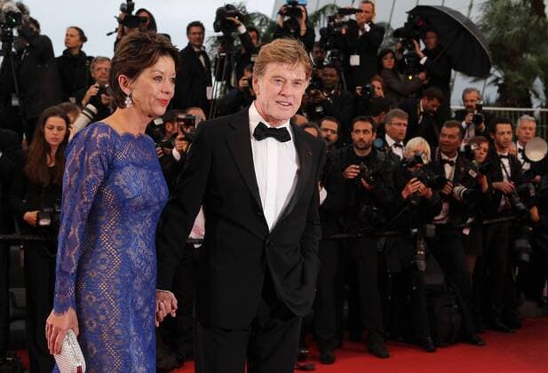 CANNES -- Cast member Robert Redford (R) poses for photos as he arrives for the screening of the American film All Is Lost presented out of Competition at the 66th edition of the Cannes Film Festival in Cannes, southern France, May 22, 2013. (Xinhua Gao Jing)(axy) FRANCE-CANNES-FILM FESTIVAL-ALL IS LOST-PREMIERE 